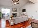 Well-lit living room featuring hardwood floors, a cozy fireplace, contemporary decor, and a sliding door to the balcony at 5007 Sharon Rd # R, Charlotte, NC 28210