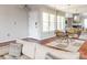 Spacious living area showcasing hardwood floors, a dining set, and a view to a living space through mirrored wall at 5007 Sharon Rd # R, Charlotte, NC 28210