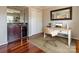 A home office with hardwood floors, a desk, and a built-in bar area at 5007 Sharon Rd # R, Charlotte, NC 28210