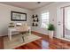 Bright home office space featuring hardwood floors, a desk, and a window at 5007 Sharon Rd # R, Charlotte, NC 28210