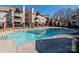 Inviting community pool surrounded by well-maintained buildings, perfect for relaxing and enjoying sunny days at 5007 Sharon Rd # R, Charlotte, NC 28210