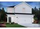 Charming two-story home with a two-car garage, black roof, and white siding nestled on a well-manicured lawn at 5020 Poplin Vly, Cherryville, NC 28021