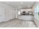 Open concept kitchen featuring stainless steel appliances and breakfast bar overlooking living space at 552 Ridge Ave, Mooresville, NC 28115