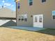 Backyard featuring a small patio, neutral siding, and a view of neighboring houses at 5532 Muckross Ln, Fort Mill, SC 29707