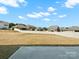 Wide shot of a spacious backyard featuring a white fence, large yard, and patio at 5532 Muckross Ln, Fort Mill, SC 29707