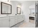 Bright bathroom featuring double sinks, a view to the Primary bedroom, and tiled floors at 5532 Muckross Ln, Fort Mill, SC 29707