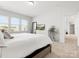 Airy bedroom featuring carpeted floors, a large bed, a dresser, and natural light at 5532 Muckross Ln, Fort Mill, SC 29707