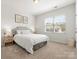 Well-lit bedroom with a window and carpet at 5532 Muckross Ln, Fort Mill, SC 29707