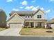 Beautiful two-story home with a covered porch, attached garage, and manicured front lawn under a bright sky at 5532 Muckross Ln, Fort Mill, SC 29707