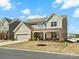 Attractive two-story home with a covered front porch and a well-maintained lawn at 5532 Muckross Ln, Fort Mill, SC 29707