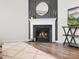 Close up of modern fireplace with white mantle and decorative details in a cozy living room setting at 5532 Muckross Ln, Fort Mill, SC 29707