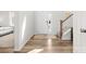 Bright, naturally lit foyer showcasing wood flooring and a staircase leading to the upper level at 5532 Muckross Ln, Fort Mill, SC 29707
