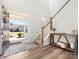 Bright foyer with wood floors, staircase, and a view of the neighborhood through the front door at 5532 Muckross Ln, Fort Mill, SC 29707
