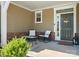 Charming front porch with seating and a decorative wreath on the front door at 5532 Muckross Ln, Fort Mill, SC 29707