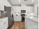 Kitchen featuring stainless appliances, white cabinets and subway tile backsplash at 5532 Muckross Ln, Fort Mill, SC 29707