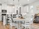 Bright eat-in kitchen with white cabinets, stainless appliances and island with pendant lighting at 5532 Muckross Ln, Fort Mill, SC 29707