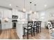 Bright kitchen with white cabinets, stainless appliances and island with pendant lighting at 5532 Muckross Ln, Fort Mill, SC 29707