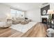 Bright living room with modern fireplace, plush sofa, hardwood floors, and large windows at 5532 Muckross Ln, Fort Mill, SC 29707