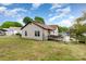 Home exterior showcasing a grassy backyard with a deck, basketball hoop, and chainlink fence at 557 Hunter Ave, Kannapolis, NC 28083