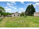 Exterior shot of a home with a spacious backyard, a shed, and a grassy lawn at 557 Hunter Ave, Kannapolis, NC 28083