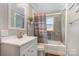 Clean bathroom featuring a shower-tub combo with neutral colored tile and a classic vanity at 557 Hunter Ave, Kannapolis, NC 28083