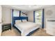Comfortable bedroom featuring a luxurious blue velvet bed frame, neutral walls, and two windows at 557 Hunter Ave, Kannapolis, NC 28083