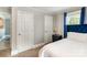 This cozy bedroom boasts plush carpets, three doors, and is furnished with a blue velvet bed frame at 557 Hunter Ave, Kannapolis, NC 28083