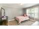 Cozy bedroom featuring neutral walls, carpeted floor, and a metal bed frame with a window view at 557 Hunter Ave, Kannapolis, NC 28083