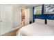 A view from the bedroom into an ensuite bathroom featuring neutral walls, with a blue velvet bed frame at 557 Hunter Ave, Kannapolis, NC 28083