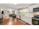 Bright kitchen featuring white cabinets, stainless steel appliances, and hardwood floors at 557 Hunter Ave, Kannapolis, NC 28083