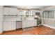 Modern kitchen with white cabinetry, stainless steel appliances, and hardwood flooring at 557 Hunter Ave, Kannapolis, NC 28083