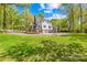 Large backyard with circle driveway, lawn, and an attached garage at 621 N 9Th St, Albemarle, NC 28001