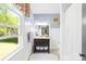 Bright bathroom features a large window, vanity, and toilet with light blue walls and a view of the outdoors at 621 N 9Th St, Albemarle, NC 28001