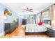 This bedroom features light blue walls, hardwood floors, and a ceiling fan, creating a comfortable and inviting space at 621 N 9Th St, Albemarle, NC 28001