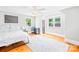 Bright bedroom features hardwood floors, two windows, and a gray walls with a bed and desk at 621 N 9Th St, Albemarle, NC 28001