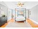 Bedroom with hardwood floors, black canopy bed, and colorful geometric designs on the walls at 621 N 9Th St, Albemarle, NC 28001