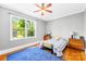 Bright bedroom featuring hardwood floors, neutral walls, and a large window offering natural light at 621 N 9Th St, Albemarle, NC 28001
