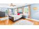 Large bedroom featuring hardwood floors, large windows, and a ceiling fan at 621 N 9Th St, Albemarle, NC 28001