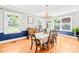 Inviting dining room with a chandelier, hardwood floors, and natural light from large windows at 621 N 9Th St, Albemarle, NC 28001