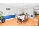 Open dining room with a chandelier, hardwood floors, and decorative chair rail at 621 N 9Th St, Albemarle, NC 28001
