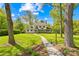 Beautiful home surrounded by mature trees and landscaping, showcasing a well-manicured lawn at 621 N 9Th St, Albemarle, NC 28001