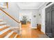 Inviting foyer with hardwood floors, staircase and glimpses of the spacious living room beyond at 621 N 9Th St, Albemarle, NC 28001