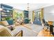 Home office with custom built-in bookshelves, large windows, and tranquil view to the outdoors at 621 N 9Th St, Albemarle, NC 28001