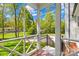 View of the yard from the porch with a brick floor and wooden railings with a basketball hoop at 621 N 9Th St, Albemarle, NC 28001