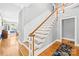 Staircase boasts hardwood steps, white risers, and natural light from the front door at 621 N 9Th St, Albemarle, NC 28001