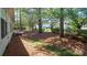 A large backyard with several tall shade trees at 6222 Meadow Glen Ln, Harrisburg, NC 28075