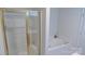 Inviting bathroom with gold-trimmed shower, a soaking tub, and tiled walls at 6222 Meadow Glen Ln, Harrisburg, NC 28075