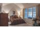 Comfortable bedroom with lots of natural light, a decorative painting, and a spacious window at 6222 Meadow Glen Ln, Harrisburg, NC 28075