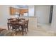 Bright dining area features wood table, seating for four, and easy access to kitchen at 6222 Meadow Glen Ln, Harrisburg, NC 28075