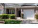 Inviting brick townhome featuring an attached one car garage, a front porch and manicured landscaping at 6222 Meadow Glen Ln, Harrisburg, NC 28075